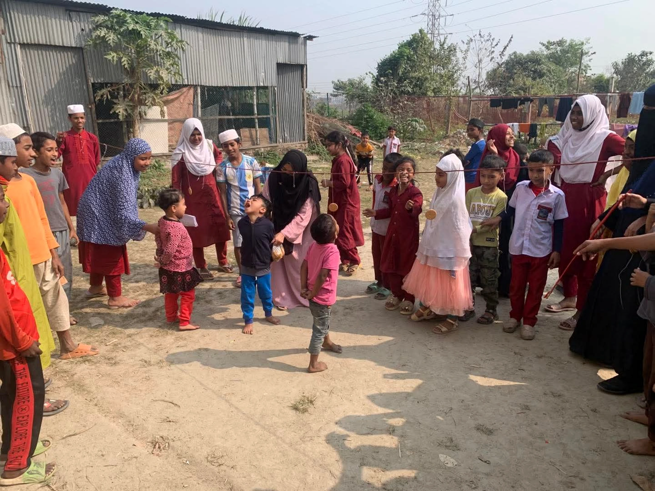 Children participating outdoors at Shahbaz Academy